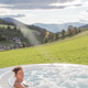 August 21, 2021: woman in a swimsuit from the back relaxes in an outdoor hot tub, with a green lawn August 21, 2021: woman in a swimsuit from the back relaxes in an outdoor hot tub, with a green lawn - PhotoDune Item for Sale