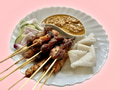 A plate of chicken, beef and mutton satay served with nasi impit and peanut sauce A plate of chicken, beef and mutton satay served with nasi impit and peanut sauce - PhotoDune Item for Sale