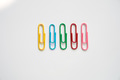 Colored paper clips close-up on a white background Colored paper clips close-up on a white background - PhotoDune Item for Sale