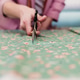 senior woman working in atelier shop with rolls of fabrics. Cutting fabrics. Small business senior woman working in atelier shop with rolls of fabrics. Cutting fabrics. Small business - PhotoDune Item for Sale