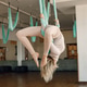 Fit young woman doing fly yoga exercises in fitness studio Fit young woman doing fly yoga exercises in fitness studio - PhotoDune Item for Sale