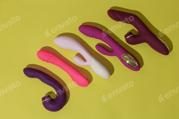 A lot of different dildo vibrators on yellow background with shadows. Sex toy for adult Stock Photo by KostiantynVoitenko A lot of different dildo vibrators on yellow background with shadows. Sex toy for adult Stock Photo by KostiantynVoitenko
