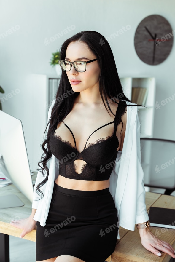 Seductive secretary in bra and shirt standing near working table in office Stock Photo by LightFieldStudios Seductive secretary in bra and shirt standing near working table in office Stock Photo by LightFieldStudios