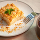 Delicious napoleon cake with mint being served on white plate Delicious napoleon cake with mint being served on white plate - PhotoDune Item for Sale