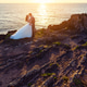 Bride and groom contemplating each other on a cliff Bride and groom contemplating each other on a cliff - PhotoDune Item for Sale