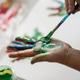 Child painting its hands with colorful paint Child painting its hands with colorful paint - PhotoDune Item for Sale