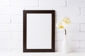 Black brown frame mockup with soft yellow orchid in vase Black brown frame mockup with soft yellow orchid in vase - PhotoDune Item for Sale