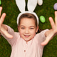 Excited girl lying on grass near Easter eggs Excited girl lying on grass near Easter eggs - PhotoDune Item for Sale