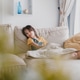 Young toddler girl sitting on the couch watching television in living room Young toddler girl sitting on the couch watching television in living room - PhotoDune Item for Sale