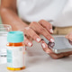 Woman checking medication timing on a smartphone app to track daily pill intake. Woman checking medication timing on a smartphone app to track daily pill intake. - PhotoDune Item for Sale