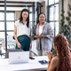 Colleagues in modern office celebrating success with smiles and applause Colleagues in modern office celebrating success with smiles and applause - PhotoDune Item for Sale