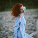 Red haired woman enjoying spring nature feeling serene Red haired woman enjoying spring nature feeling serene - PhotoDune Item for Sale