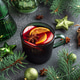 Holiday Mulled Wine with Orange and Apple in Green Mug Surrounded by Christmas Decor Holiday Mulled Wine with Orange and Apple in Green Mug Surrounded by Christmas Decor - PhotoDune Item for Sale