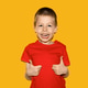 Child in red t-shirt on yellow background, boy 5 years old Child in red t-shirt on yellow background, boy 5 years old - PhotoDune Item for Sale