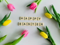 Flat lay of Happy Easter written with tile letters with yellow & pink tulips. Flat lay of Happy Easter written with tile letters with yellow & pink tulips. - PhotoDune Item for Sale