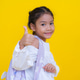Smiling girl showing thumbs up sign on yellow background Smiling girl showing thumbs up sign on yellow background - PhotoDune Item for Sale