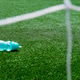 Water bottle on the green grass of a soccer field with net Water bottle on the green grass of a soccer field with net - PhotoDune Item for Sale