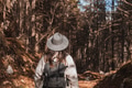 Rear view of girl wearing backpack, hiking in forest in autumn Rear view of girl wearing backpack, hiking in forest in autumn - PhotoDune Item for Sale