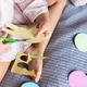 Young child cutting bunny shapes out of colored paper on a bed Young child cutting bunny shapes out of colored paper on a bed - PhotoDune Item for Sale