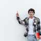 Teenager student pointing aside with fingers hand gesture at white copy space Teenager student pointing aside with fingers hand gesture at white copy space - PhotoDune Item for Sale
