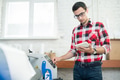 Man watching tablet and using printing machine Man watching tablet and using printing machine - PhotoDune Item for Sale