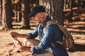 Mature male hiker using digital tablet for navigation Mature male hiker using digital tablet for navigation - PhotoDune Item for Sale