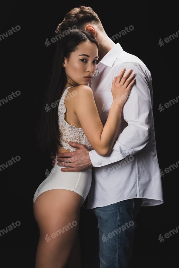 sexy asian woman in white lingerie embracing boyfriend and looking at camera isolated on black Stock Photo by LightFieldStudios sexy asian woman in white lingerie embracing boyfriend and looking at camera isolated on black Stock Photo by LightFieldStudios