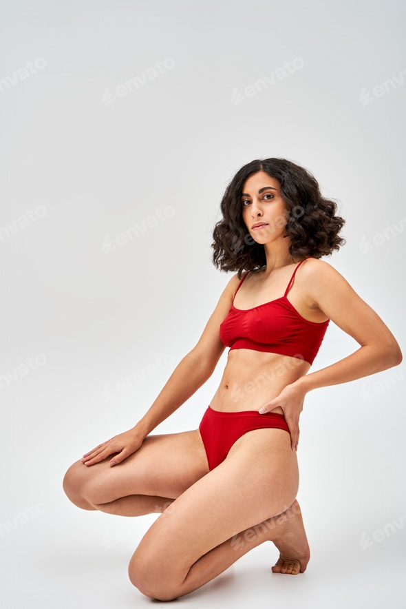 Full length of sexy middle eastern brunette woman in red lingerie holding hand on hip Stock Photo by LightFieldStudios Full length of sexy middle eastern brunette woman in red lingerie holding hand on hip Stock Photo by LightFieldStudios