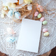 Easter-themed table setting with decorative pastel eggs and a blank notebook Easter-themed table setting with decorative pastel eggs and a blank notebook - PhotoDune Item for Sale