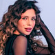 A fashion model touching her hair is photographed in a photo studio looking at the camera. A fashion model touching her hair is photographed in a photo studio looking at the camera. - PhotoDune Item for Sale