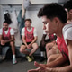 Athletes listening to coach in locker room concentrating on strategy Athletes listening to coach in locker room concentrating on strategy - PhotoDune Item for Sale