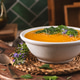 Creamy Pumpkin Soup with Fresh Herbs and Edible Flowers in a Rustic Kitchen Setting Creamy Pumpkin Soup with Fresh Herbs and Edible Flowers in a Rustic Kitchen Setting - PhotoDune Item for Sale