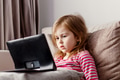 Cute todller girl sitting on couch, using tablet pad laptop gadget, watching cartoons at home Cute todller girl sitting on couch, using tablet pad laptop gadget, watching cartoons at home - PhotoDune Item for Sale