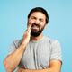 Man experiencing severe toothache on blue background Man experiencing severe toothache on blue background - PhotoDune Item for Sale
