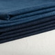 stack of folded natural dark blue color denim fabric. stack of folded natural dark blue color denim fabric. - PhotoDune Item for Sale