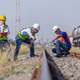 Railway Engineering Team Inspecting Rail Track at Freight Yard Railway Engineering Team Inspecting Rail Track at Freight Yard - PhotoDune Item for Sale