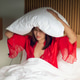 Woman Wearing Red Satin Sleepwear Covering Head With Pillow Due to Insomnia Woman Wearing Red Satin Sleepwear Covering Head With Pillow Due to Insomnia - PhotoDune Item for Sale
