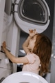 Toddler girl helps with cleaning and organizing at home, puting clothes to dryer, daily routine Toddler girl helps with cleaning and organizing at home, puting clothes to dryer, daily routine - PhotoDune Item for Sale