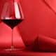 Red Wine Glass on Sculptural Red Background. Elegant Monochrome Still Life Red Wine Glass on Sculptural Red Background. Elegant Monochrome Still Life - PhotoDune Item for Sale