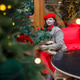 A woman in a red clothes with a bouquet of fir branches walks along the Christmas decorated streets A woman in a red clothes with a bouquet of fir branches walks along the Christmas decorated streets - PhotoDune Item for Sale