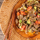 Delicious stir-fried beef with fresh vegetables and sesame served in a wooden bowl Delicious stir-fried beef with fresh vegetables and sesame served in a wooden bowl - PhotoDune Item for Sale