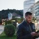 Young man wearing leather jacket checking his smartphone on the street Young man wearing leather jacket checking his smartphone on the street - PhotoDune Item for Sale