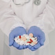 An elderly woman holds a mix of pills in her palms. An elderly woman holds a mix of pills in her palms. - PhotoDune Item for Sale