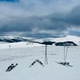 Skis in the snow and snowcapped mountains in the distance Skis in the snow and snowcapped mountains in the distance - PhotoDune Item for Sale