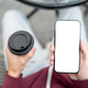 Top view of a man holding coffee cup aside white screen phone sitting on chair over concrete floor. Top view of a man holding coffee cup aside white screen phone sitting on chair over concrete floor. - PhotoDune Item for Sale