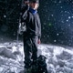 A hipster with a dog and a snowboard at night on a black background during a snowfall A hipster with a dog and a snowboard at night on a black background during a snowfall - PhotoDune Item for Sale