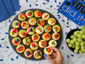 Overhead flat lay of colorful appetizers on marble counter decorated with graduation party supplies Overhead flat lay of colorful appetizers on marble counter decorated with graduation party supplies - PhotoDune Item for Sale