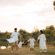 Happy young family with two children having fun in park on a sunny day Happy young family with two children having fun in park on a sunny day - PhotoDune Item for Sale
