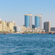 Modern skyline of Dubai Creek with traditional boats in the UAE Modern skyline of Dubai Creek with traditional boats in the UAE - PhotoDune Item for Sale