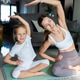 Mother and daughter practicing yoga together on a mat at home Mother and daughter practicing yoga together on a mat at home - PhotoDune Item for Sale